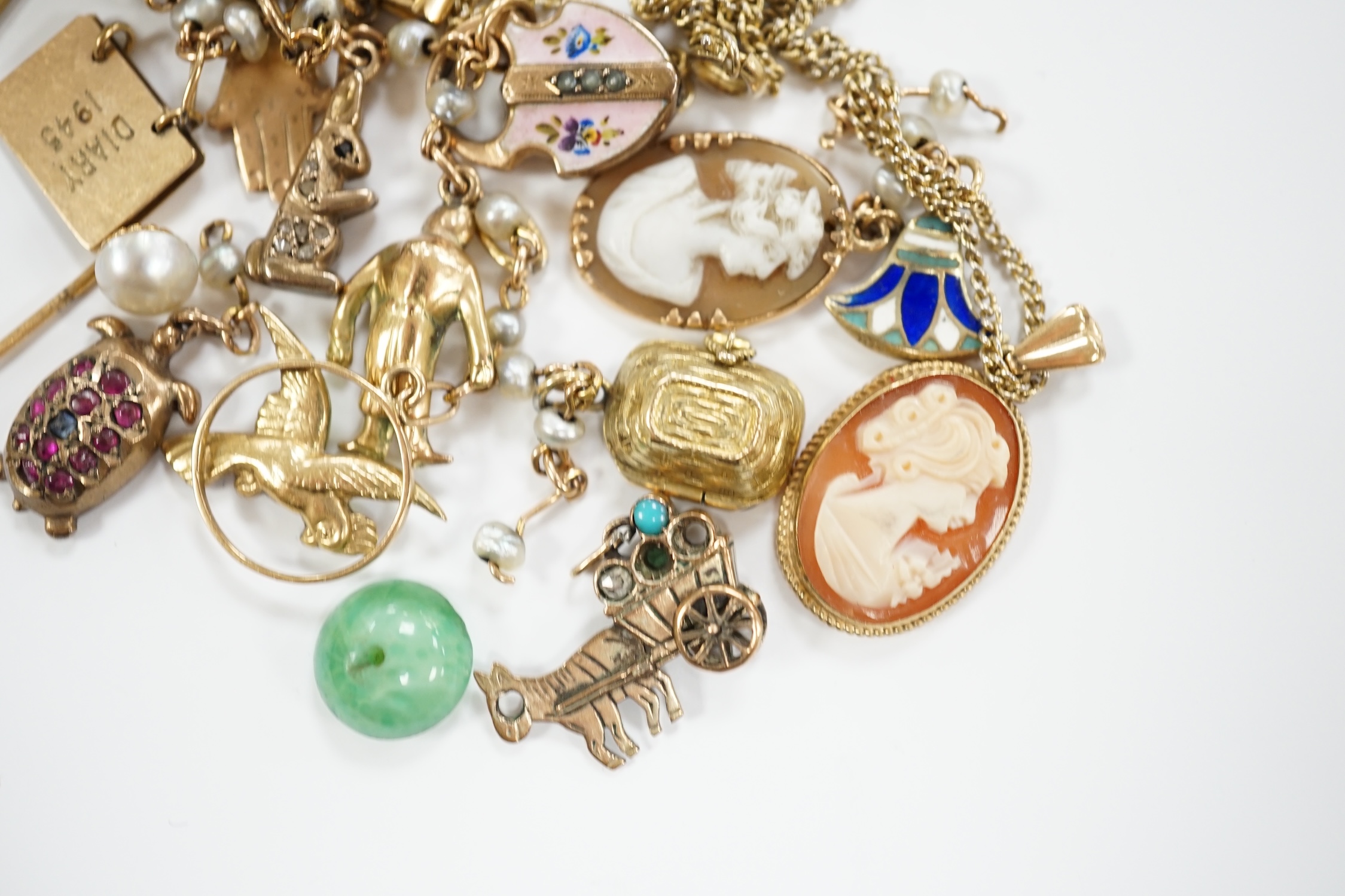 Sundry jewellery including a yellow metal charm bracelet (a.f.) with assorted charms including enamelled and 9ct, a modern 9ct gold and cameo shell pendant, on a gilt metal chain, two stick pins and three other items.